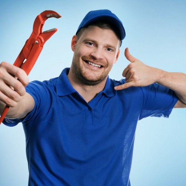 plumbing services - plumber with wrench showing phone call gestu